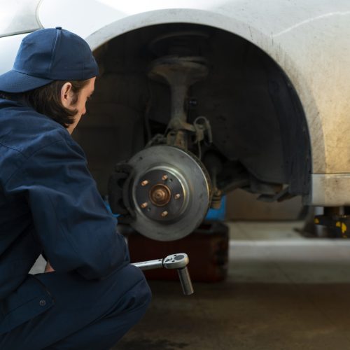 male-car-mechanic-working-car-repair-shop